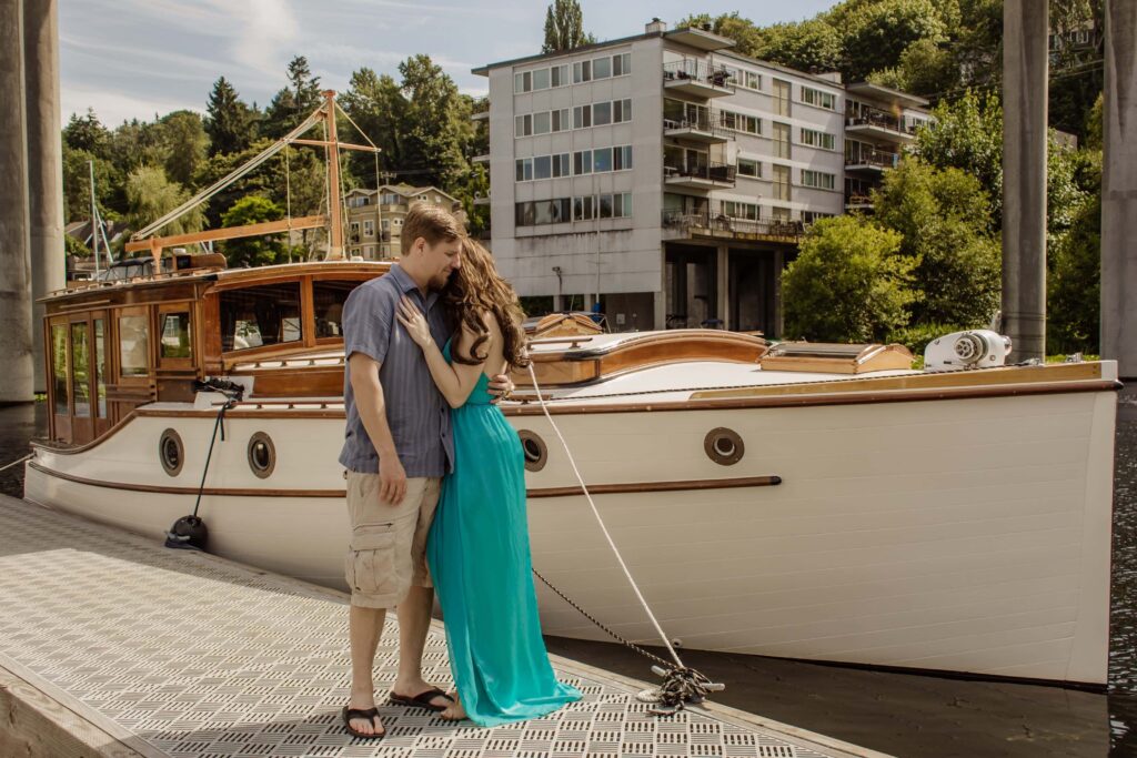 Elizabeth and Zack's original elopement on a boat on Lake Union in Seattle Zack Kissing Elizabeth's hand ofer the water ez elopements beginning
