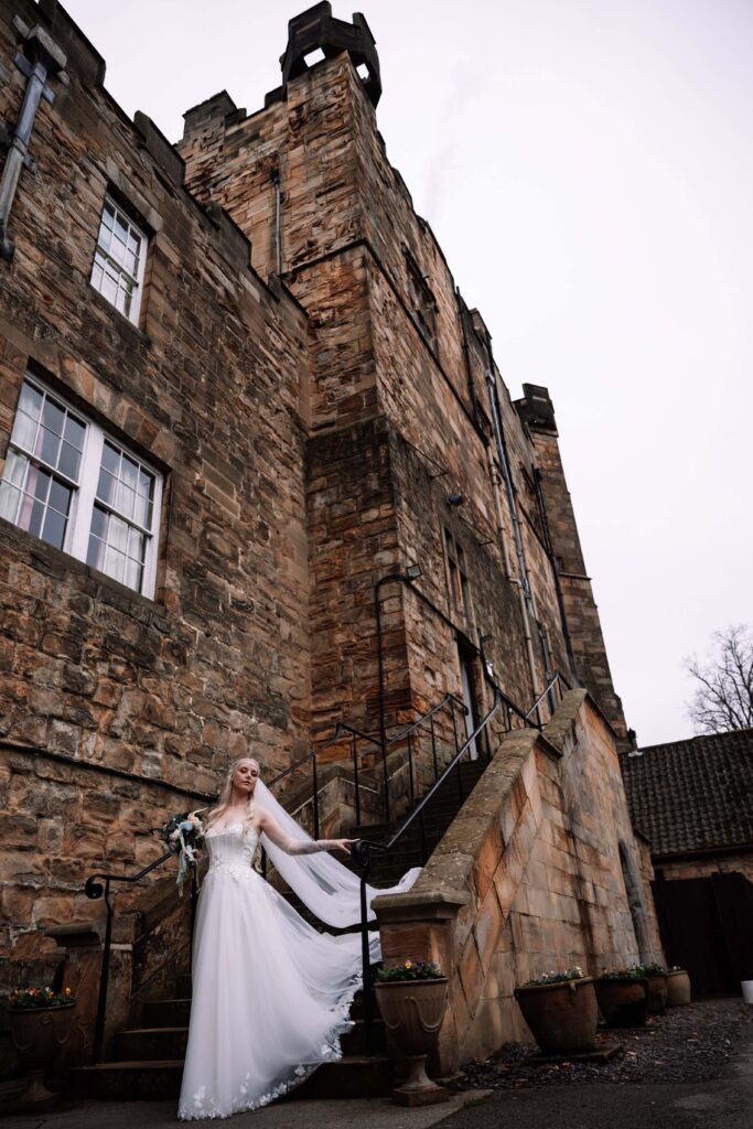 A bride descending the stairs to her elopement at Lumley Castle in the UK. 