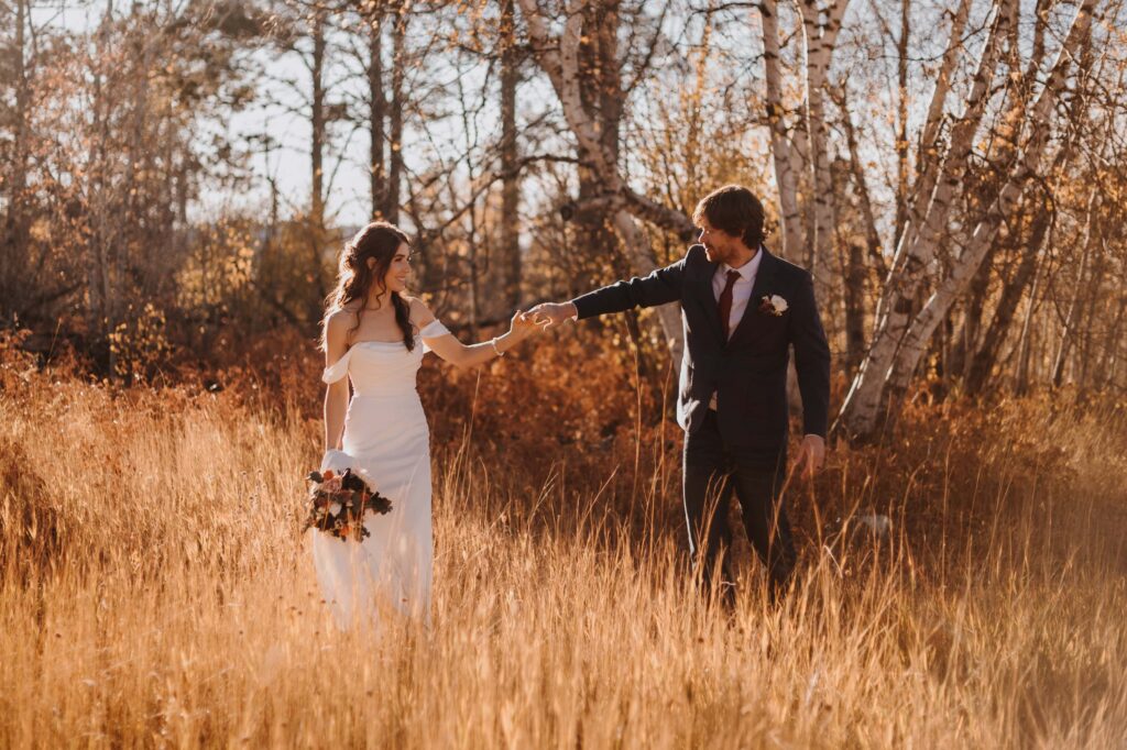 Private elopement day stroll through the tall grass.