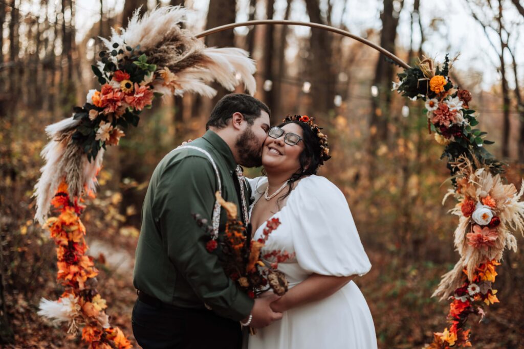 Couple share a kiss after exchanging vows in the EZ Secret Forest. 