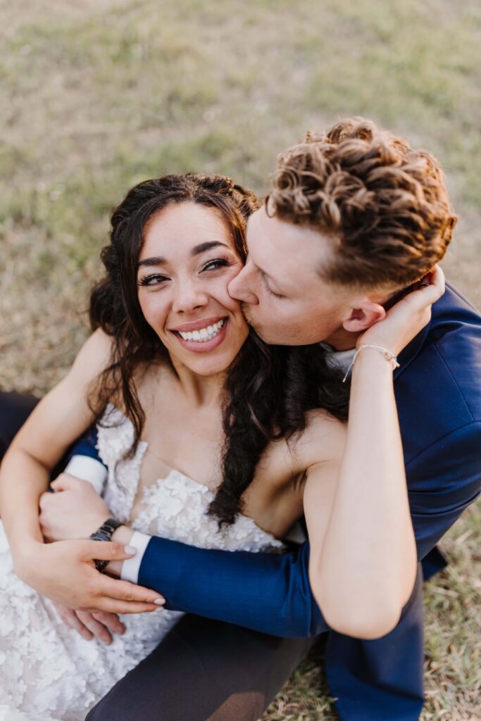 Newlywed couple embrace.