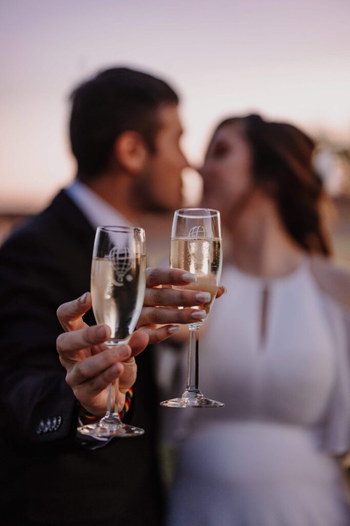 Newlyweds cheers to their first married adventure after their hot air balloon elopement.