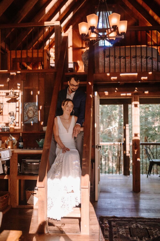 Savoring the getting ready moments, bride and groom to be share a moment on the stairs.
