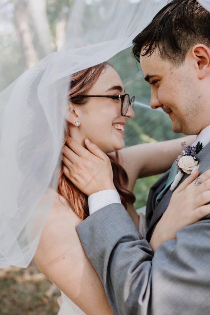 Newlyweds embracing in laughter.