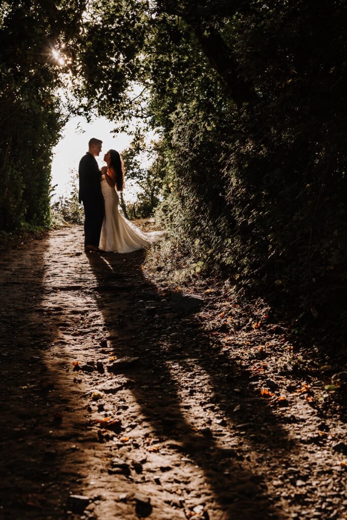 Bride and Groom under the cover of trees.
