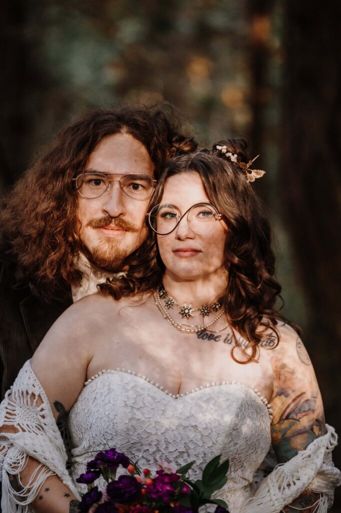 Newlyweds in dappled sunlight.