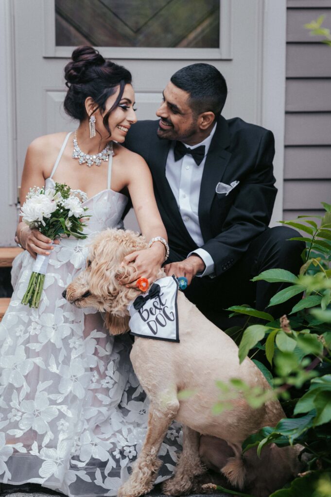 Newlyweds and their beloved dog and pet sign.