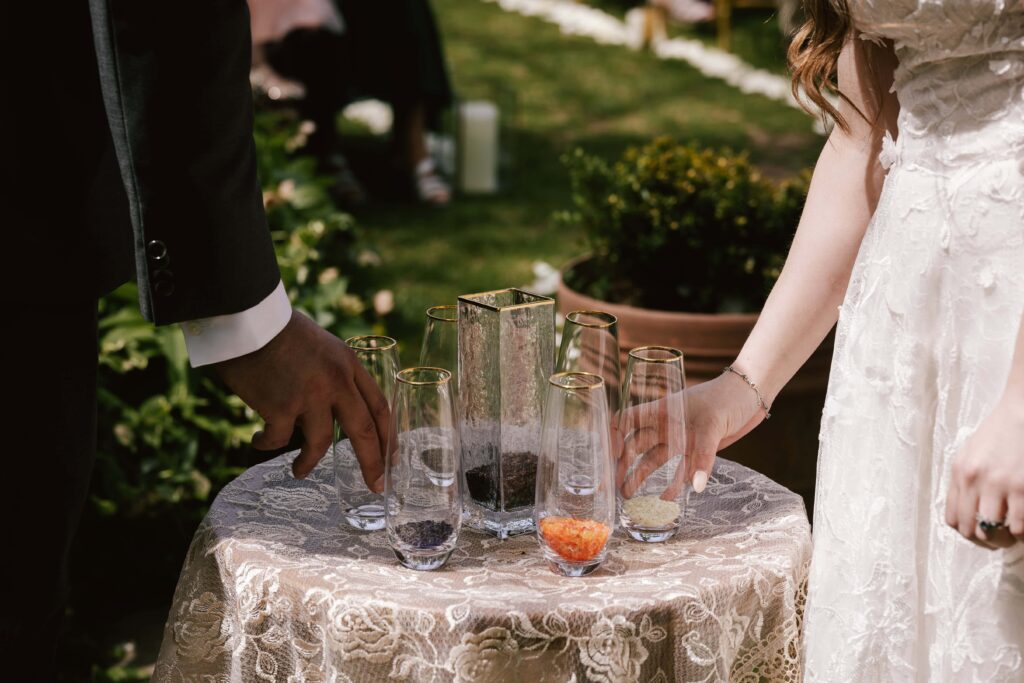  Couple performing a unity sand ceremony on their wedding day.
