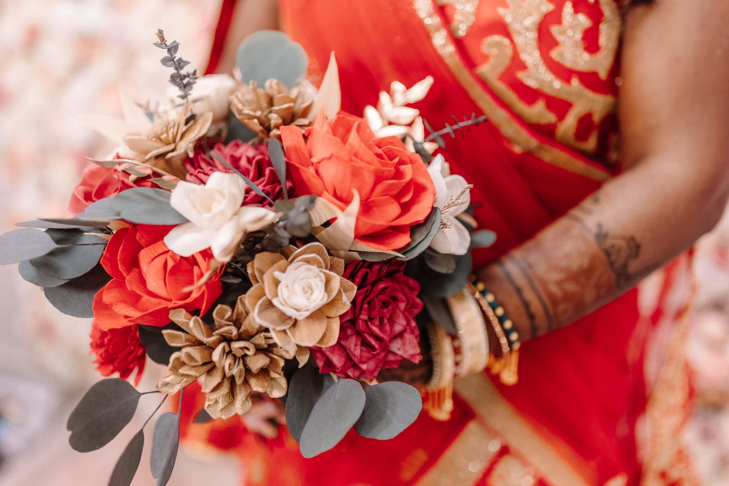 Overview of a sola wood bouquet made with red, ivory, and natural wood flowers.