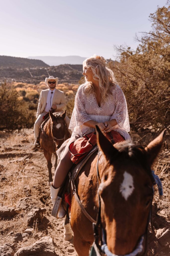 A couple sharing a horseback ride adventure before their elopement