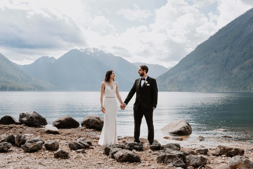 Bride and Groom walk the shores of Lake Crescent after their elopement ceremony in Olympic National Park.