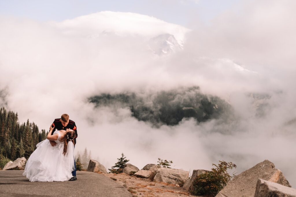 Bride and Groom take a newlywed kiss atop Mount Rainier. 