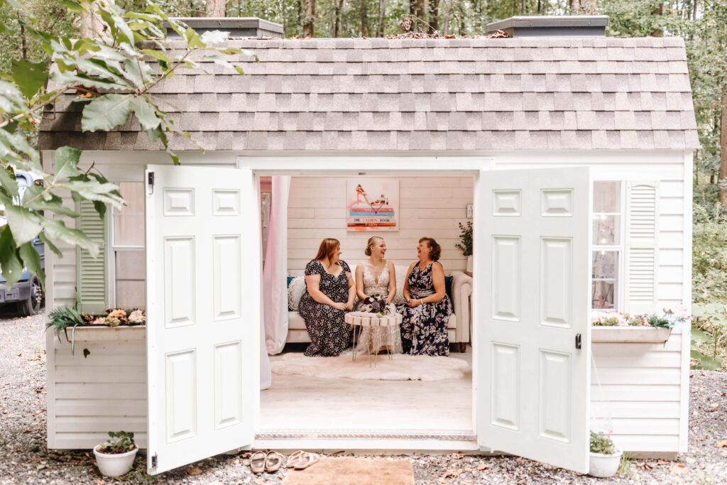 Bride and her sister and mother sit in our She Shed, sharing laughs.
