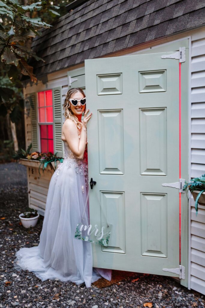 An excited bride posing beside the Bridal Suite.