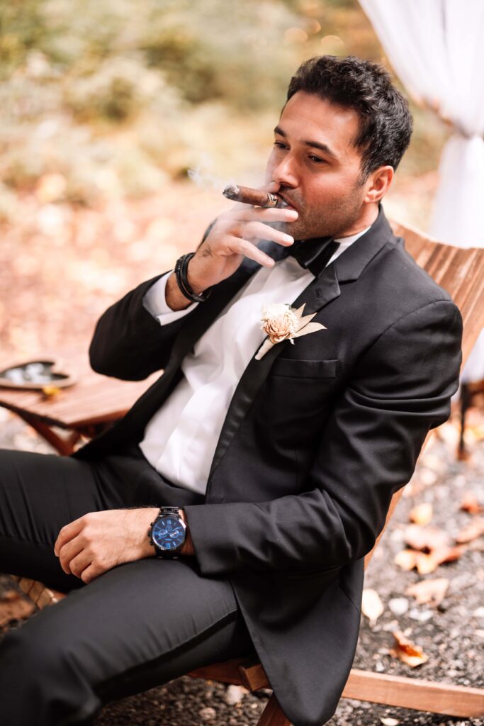 Groom smoking a cigar in the Private Forest.