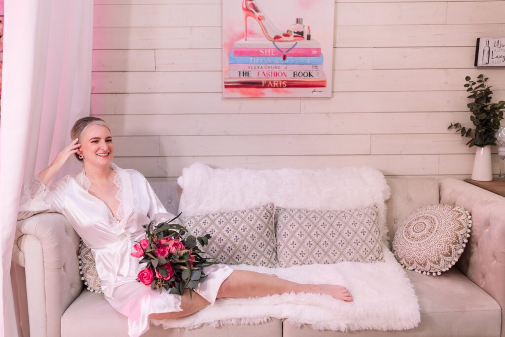 A gorgeous bride lounging on the couch in the Bridal Suite.
