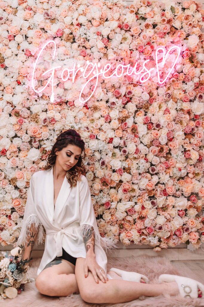 Stunning Bride in front of our pink and white flower wall.