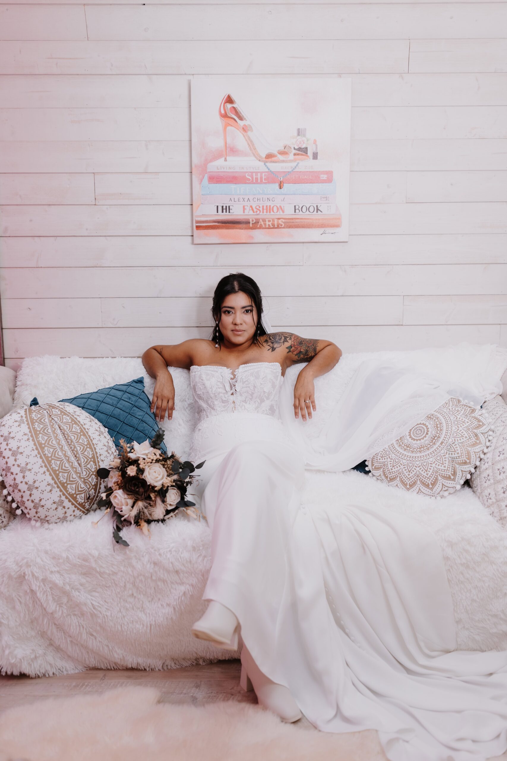 A gorgeous bride lounging on the couch in the She Shed.
