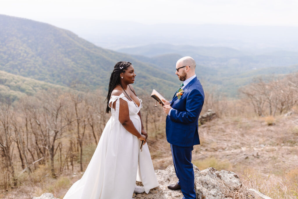 Couple exchanging reading love letters to each other before they say their "I dos."