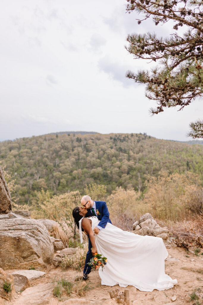 Sn intimate kiss shared atop a gorgeous mountain vista near Luray Caverns.