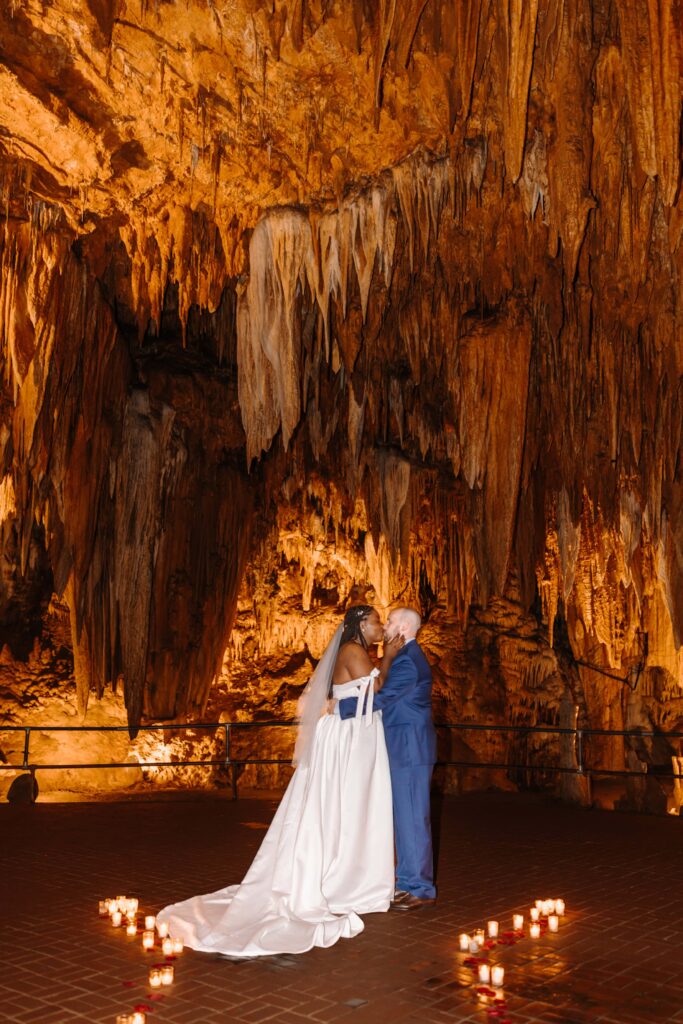 A gorgeous couple share a first married kiss in the beauty of Luray Caverns.