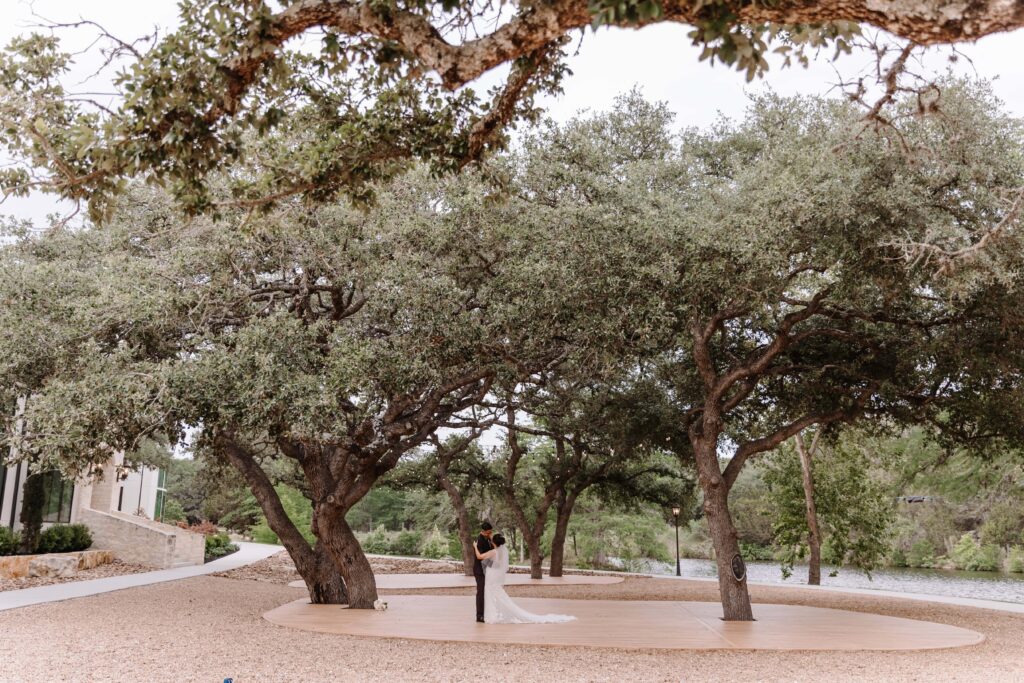 Canyon-Lake-The Preserve at Canyon Lake-TX-Elopement Small Wedding Venue in Texas bride and groom first dance under oak trees_www.ezelopements.com