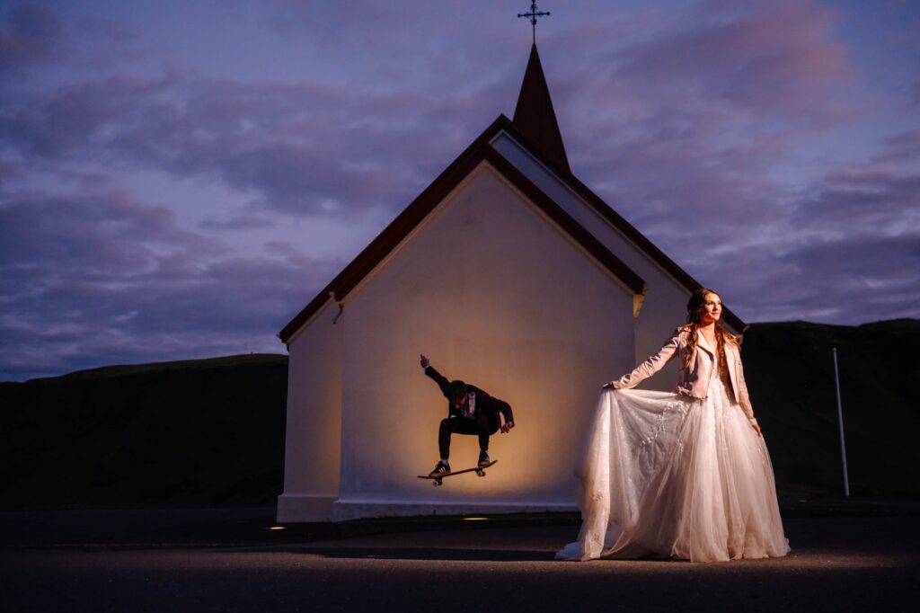 Bride and Groom in the shadow of a chapel.