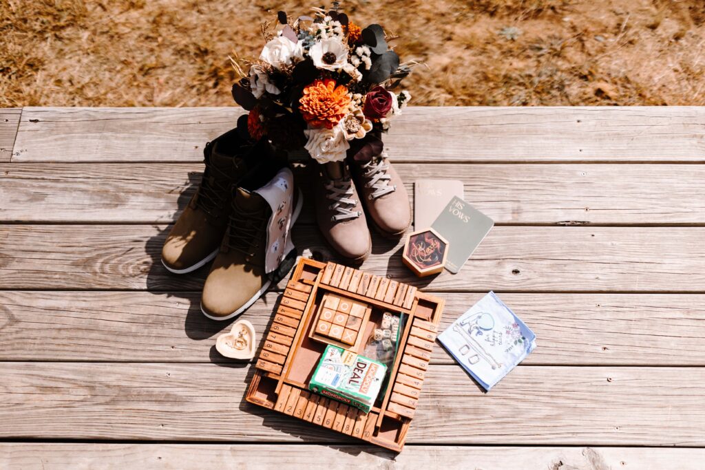 The detailed items of a couples hiking elopement in a state park lined up neatly.