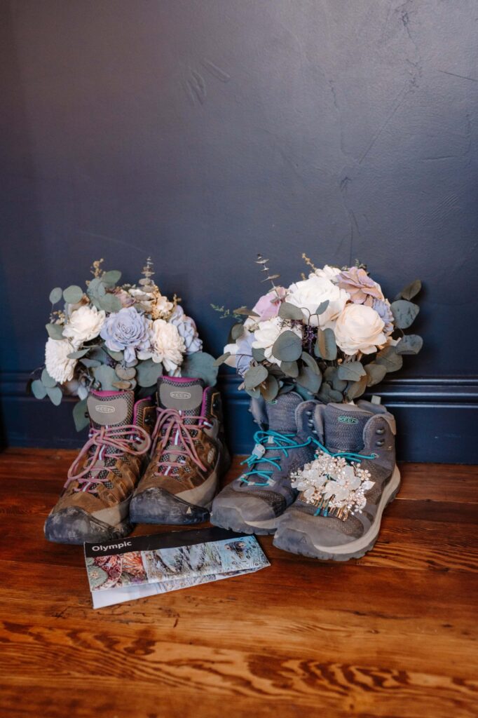 Two pairs of hiking boots with Sola Wood bouquets nestled inside them.