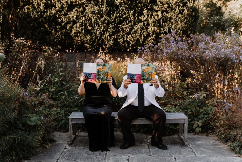 Studious couple read pose with books.