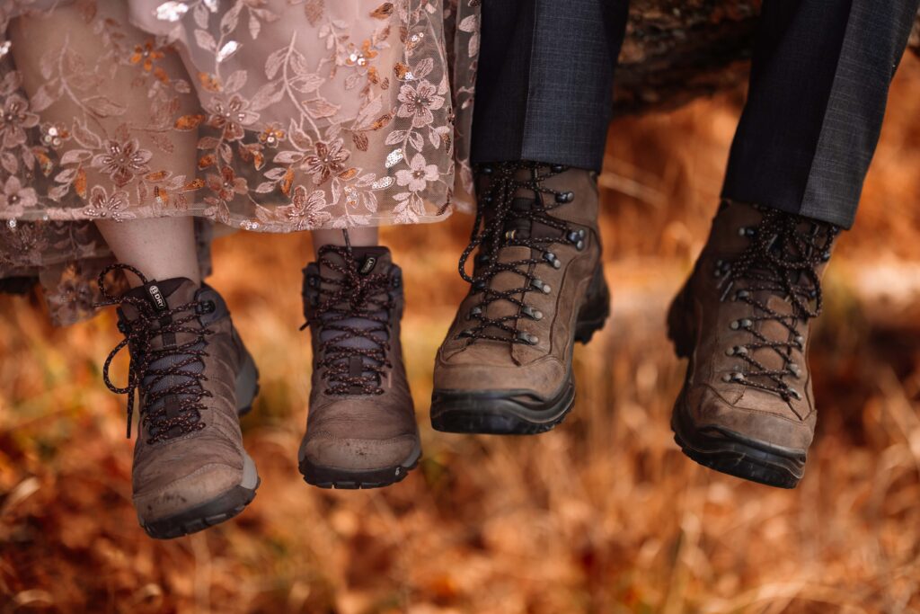Bride and groom show off their hiking boots for their state park elopement.