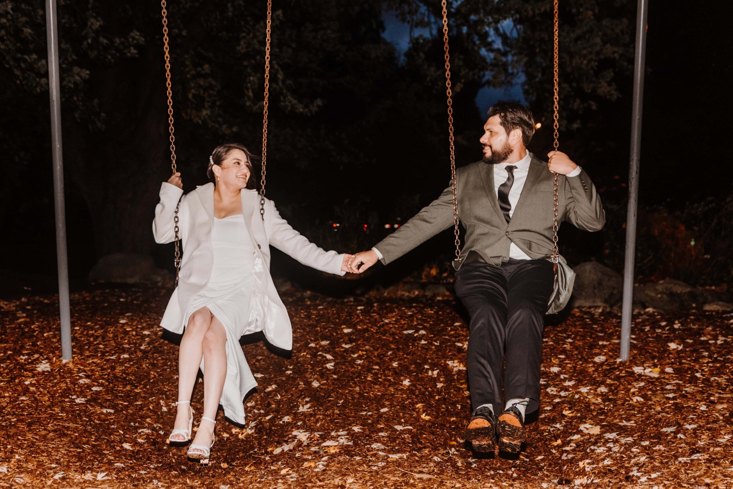Bride and Groom on a swing set.