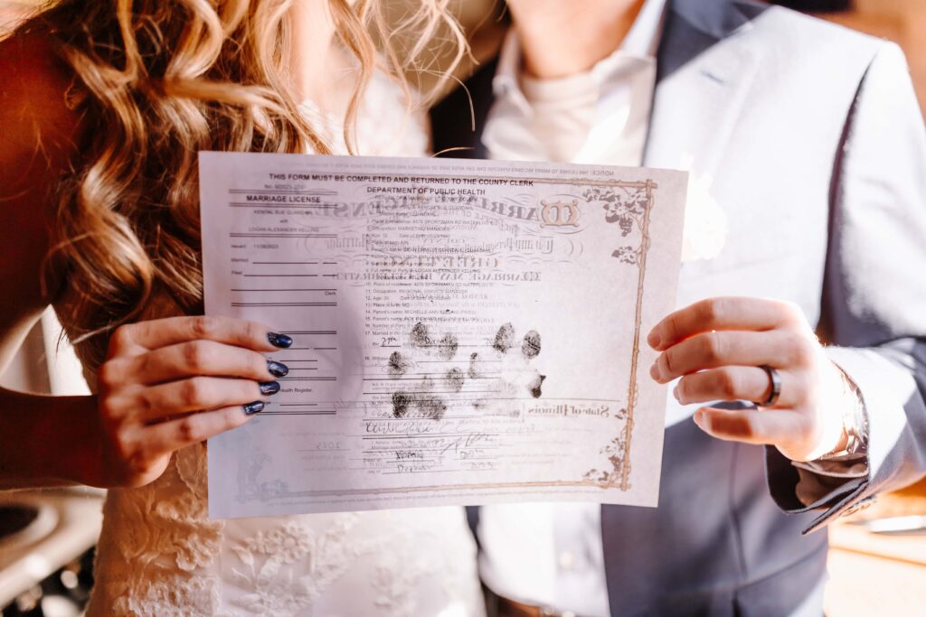 Signed marriage license with pet paw prints.
