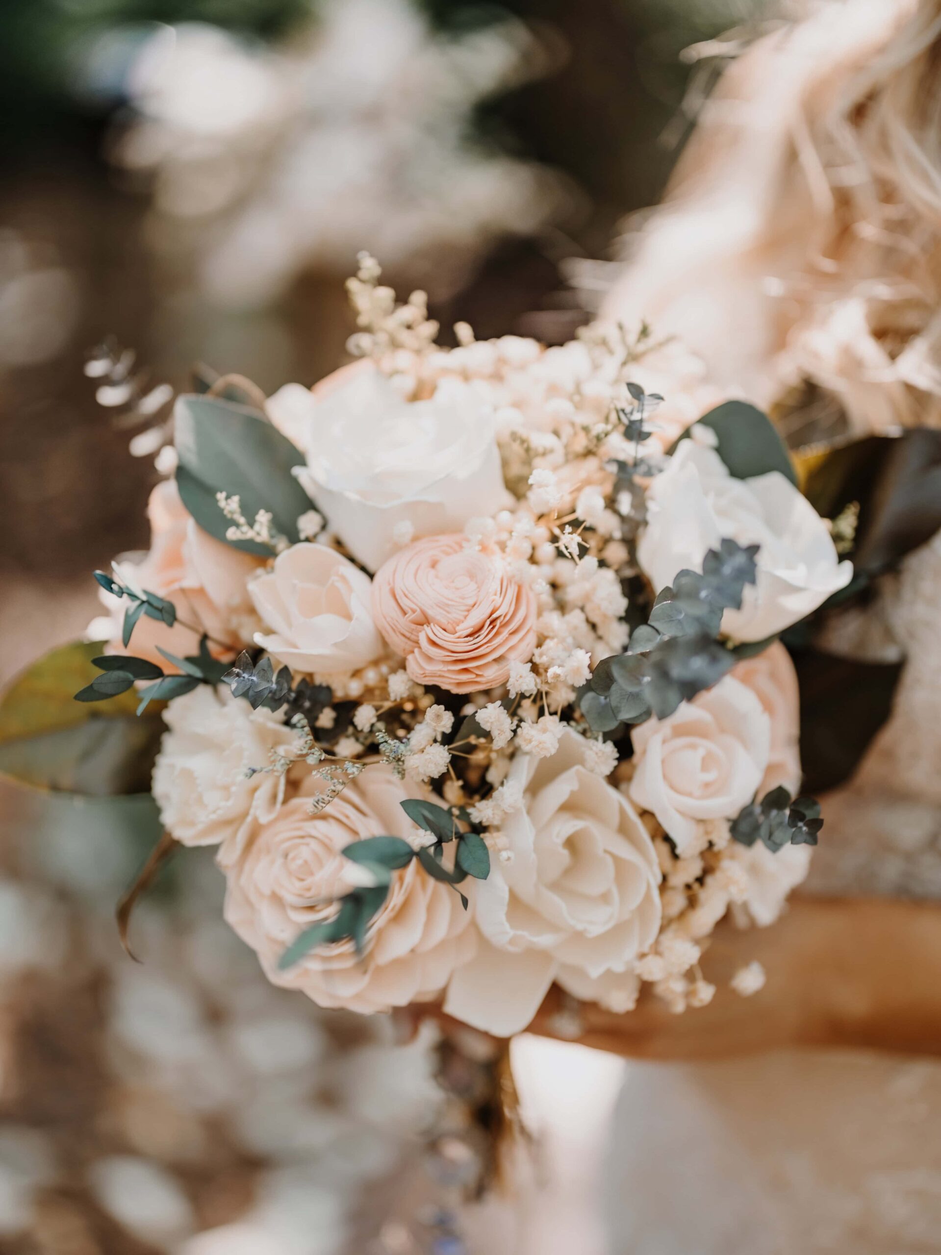 A smaller classic round bouquet made with ivory and cream sola wood flowers