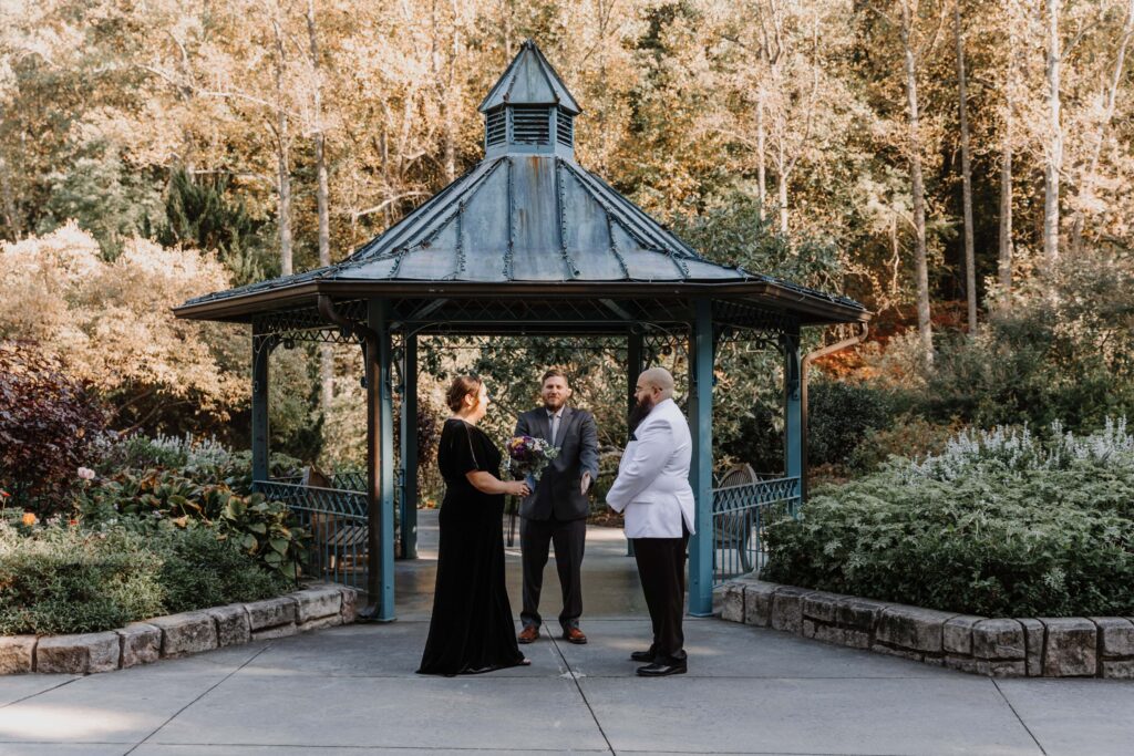 Maryland Micro-wedding: a lovely couple exchanges their vows beneath the gazebo at Brookside Gardens.