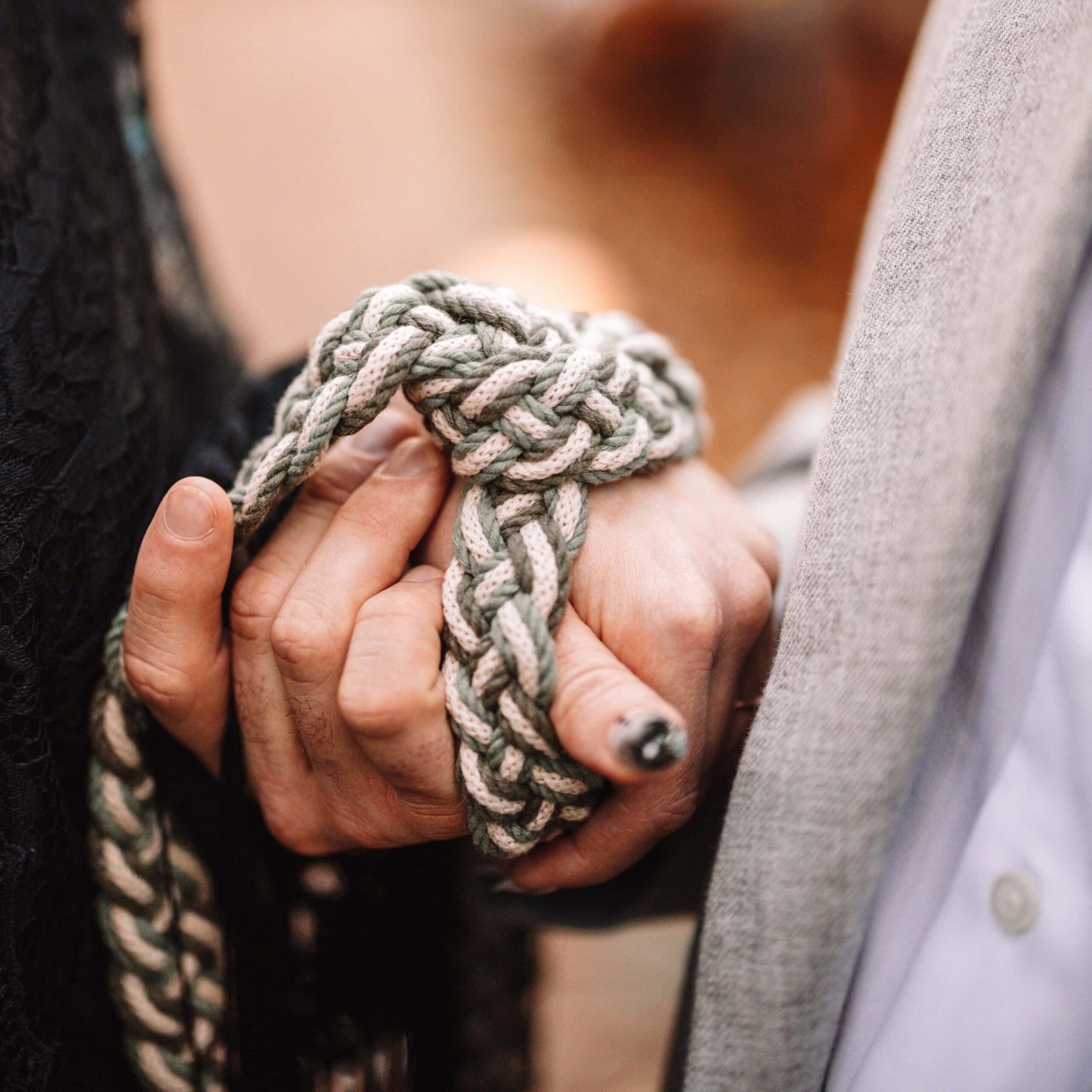 Couple preforming an unconventional handfasting ceremony on their wedding day.