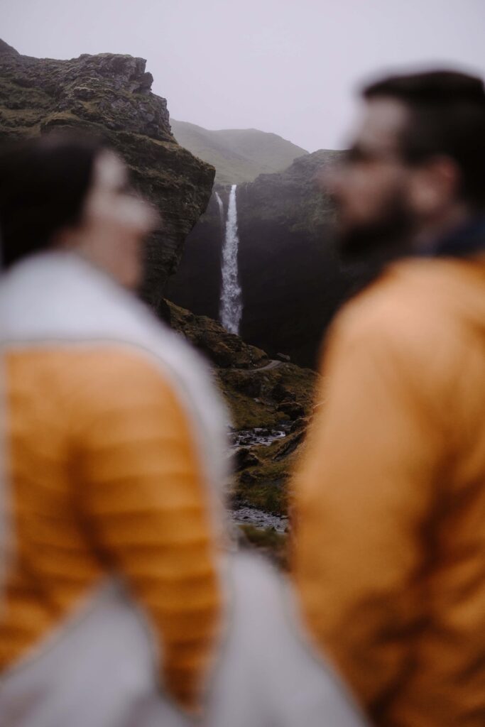 Bride and Groom looking at each other in front of Iceland Waterfall after they eloped