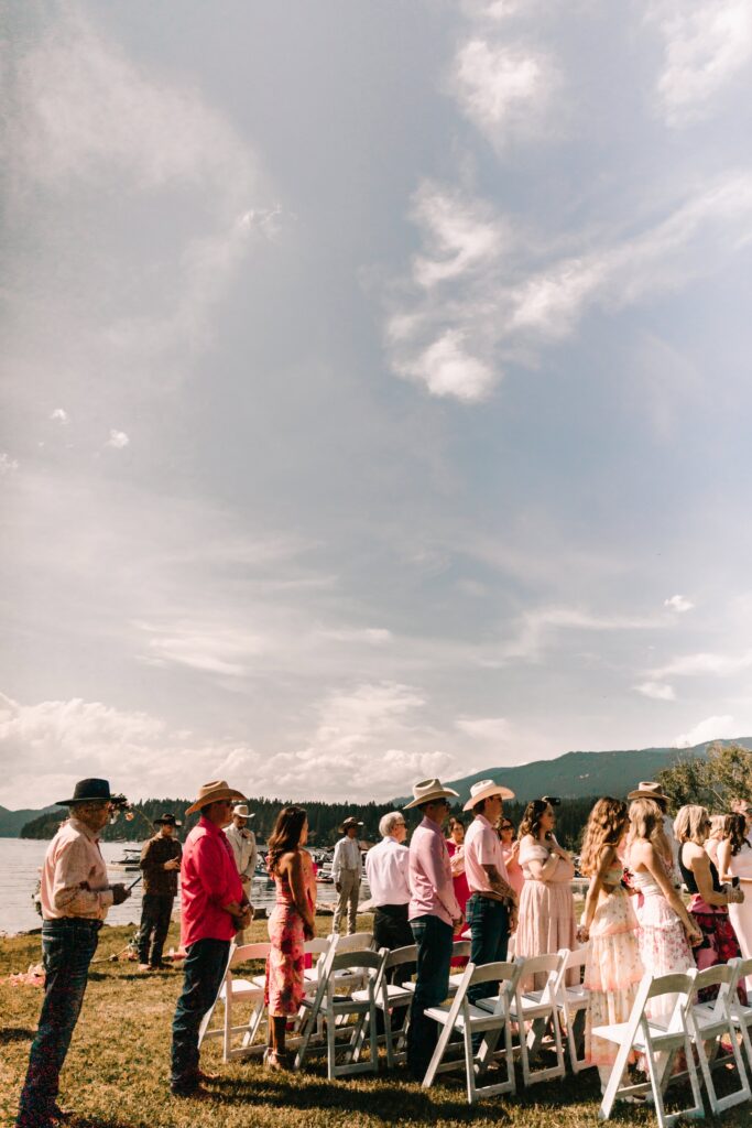 The chosen family of our couple stands as the bride enters her micro wedding. 
