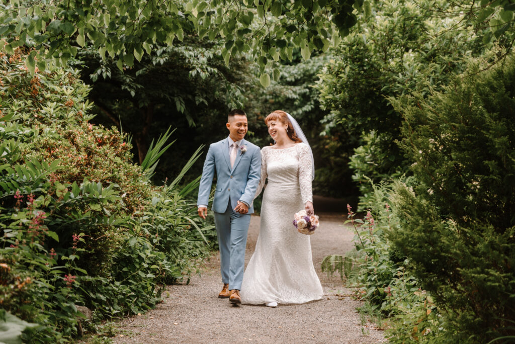 An excited couple strolling the Botanic Garden Grounds before exchanging vows at their garden style texas wedding venue.