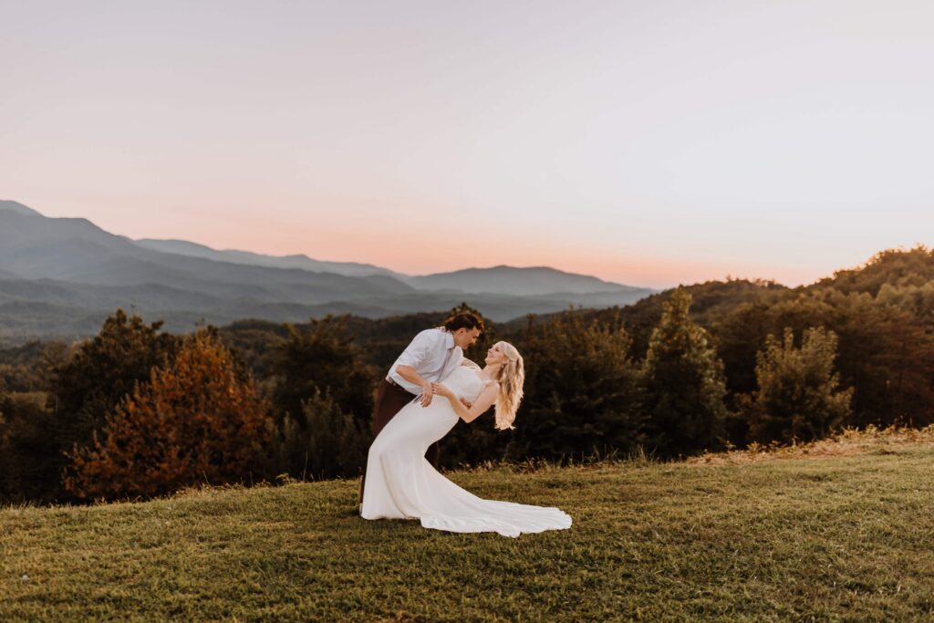 a gorgeous shot of the newlyweds in front of the setting sun over the Smoky Mountains in Tennessee.