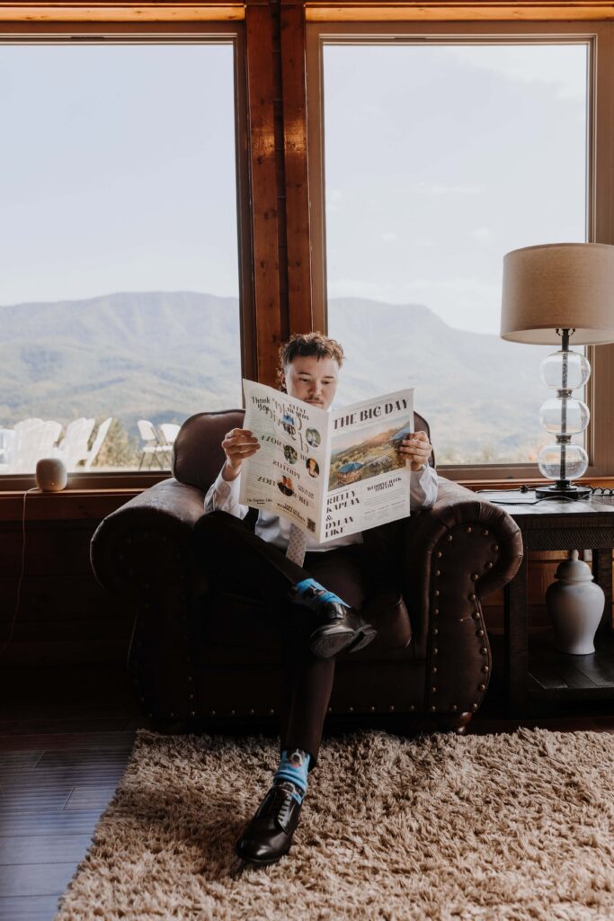 The groom spending a little time reading their custom wedding newspaper the morning of the Big Day.