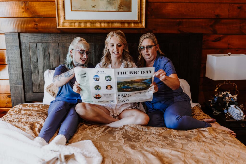 The bride, her mother, and sister share a sweet moment with their Big Day newspaper.