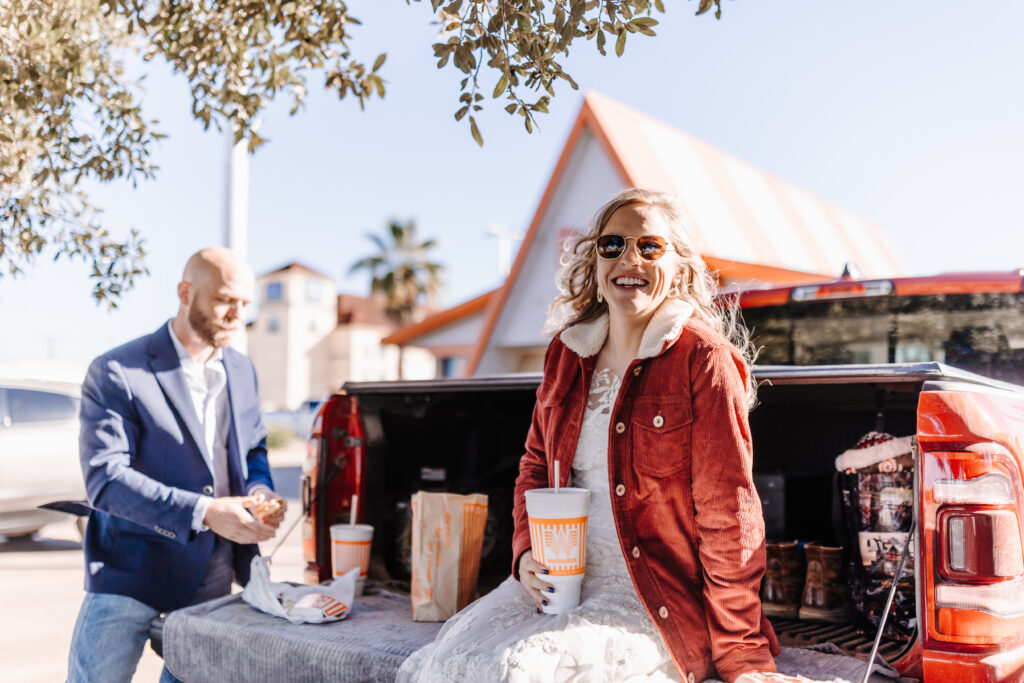 EZ Elopements newlyweds enjoying a post-elopement burger at a Texas landmark.