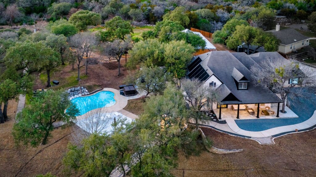 An aerial shot of the estate showing the home, pool, and reception tent in the back. 